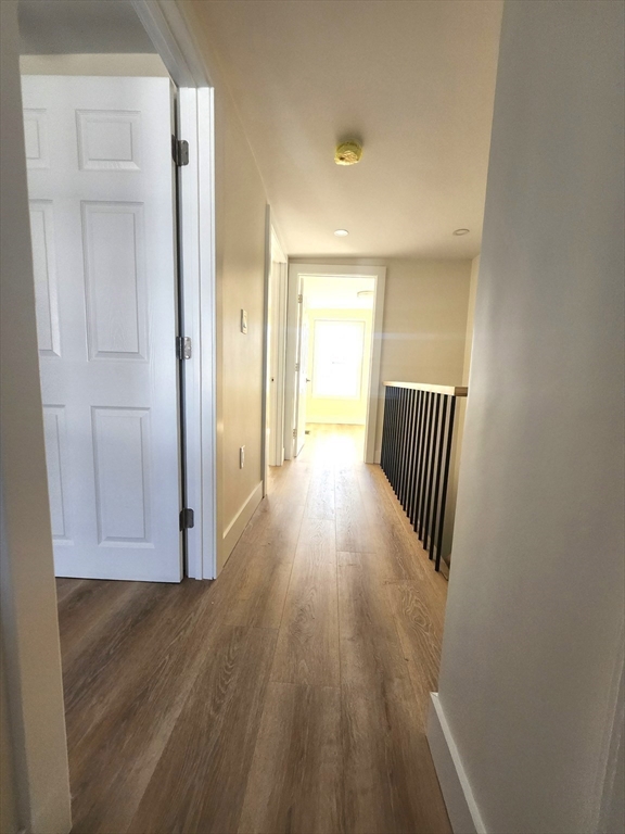 264 Bowen Street, Unit 264 Boston, MA 02127 - Photo 8 of 18 a view of a hallway with wooden floor and staircase