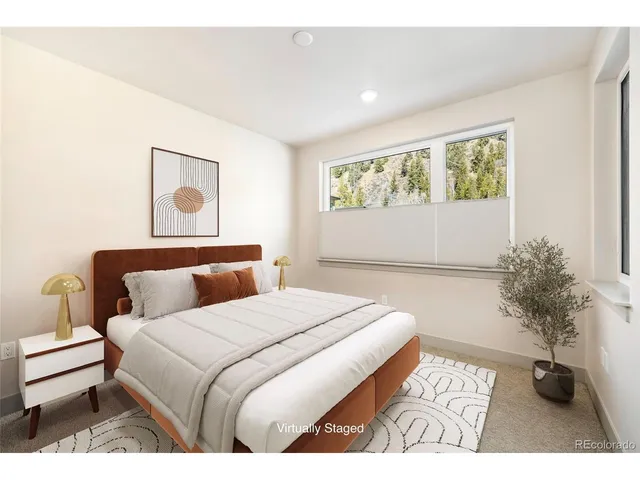 a bedroom with a bed and a potted plant