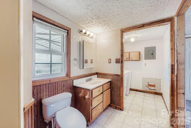 a bathroom with a sink a toilet and mirror