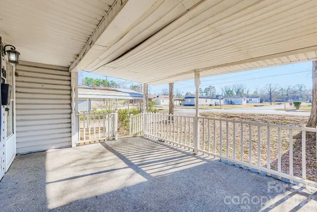 a bedroom with furniture and large windows