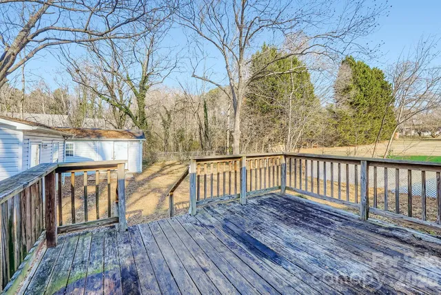 a view of balcony with wooden floor and fence