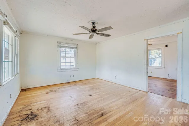 wooden floor in an empty room with a window