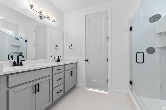 1869 South 2425 West Ogden, UT 84401 - Photo 20 of 22 Full bath with a stall shower, double vanity, and light tile patterned floors