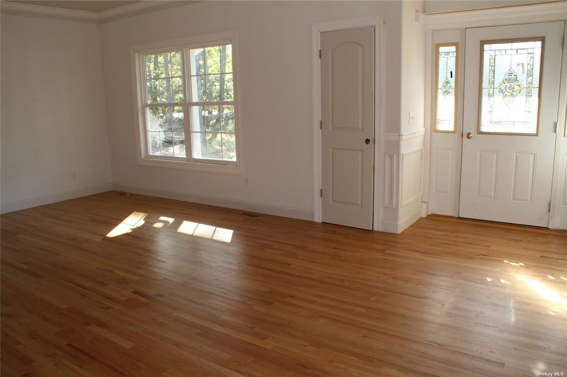 Lot 3 Eastport Manor Road Manorville, NY 11949 - Photo 6 of 6 an empty room with wooden floor and windows