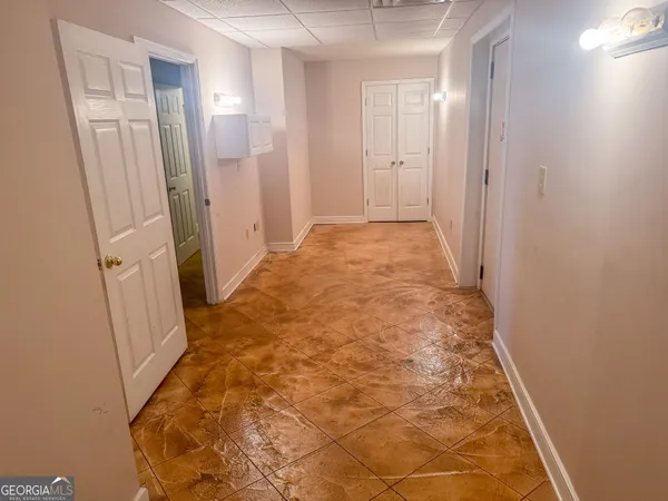 a hallway with wooden floor and furniture