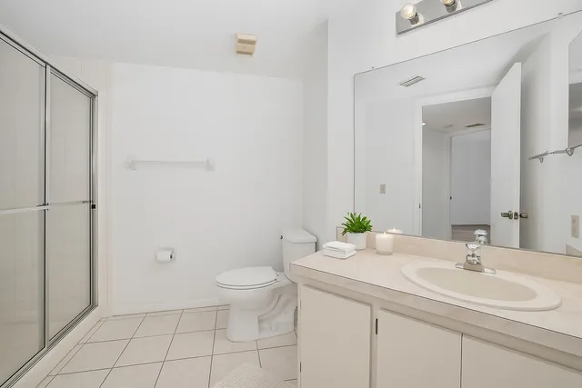 a bathroom with a sink toilet and a mirror