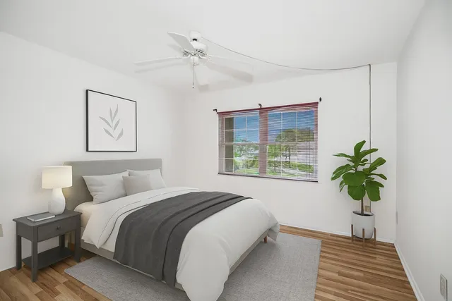 a bedroom with a bed and a window