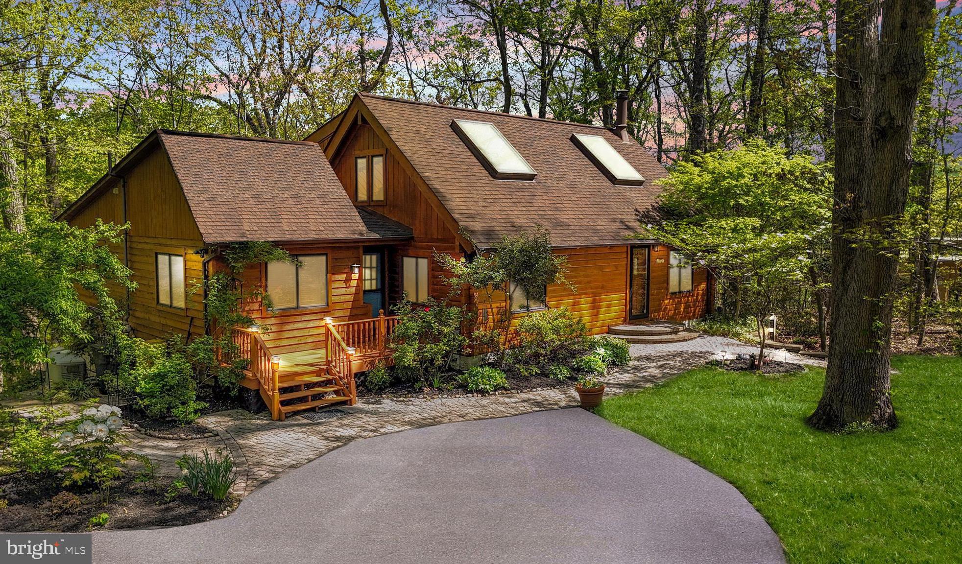 2977 Southaven Drive Annapolis, MD 21401 - Photo 1 of 56 a front view of a house with a garden and trees