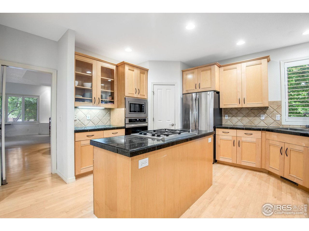 4026 Nevis Street Boulder, CO 80301 - Photo 11 of 40 a kitchen with stainless steel appliances granite countertop a refrigerator a sink and a stove