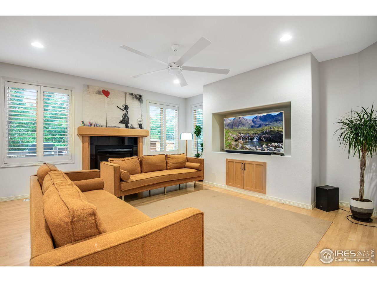 4026 Nevis Street Boulder, CO 80301 - Photo 17 of 40 a living room with furniture a fireplace and a flat screen tv