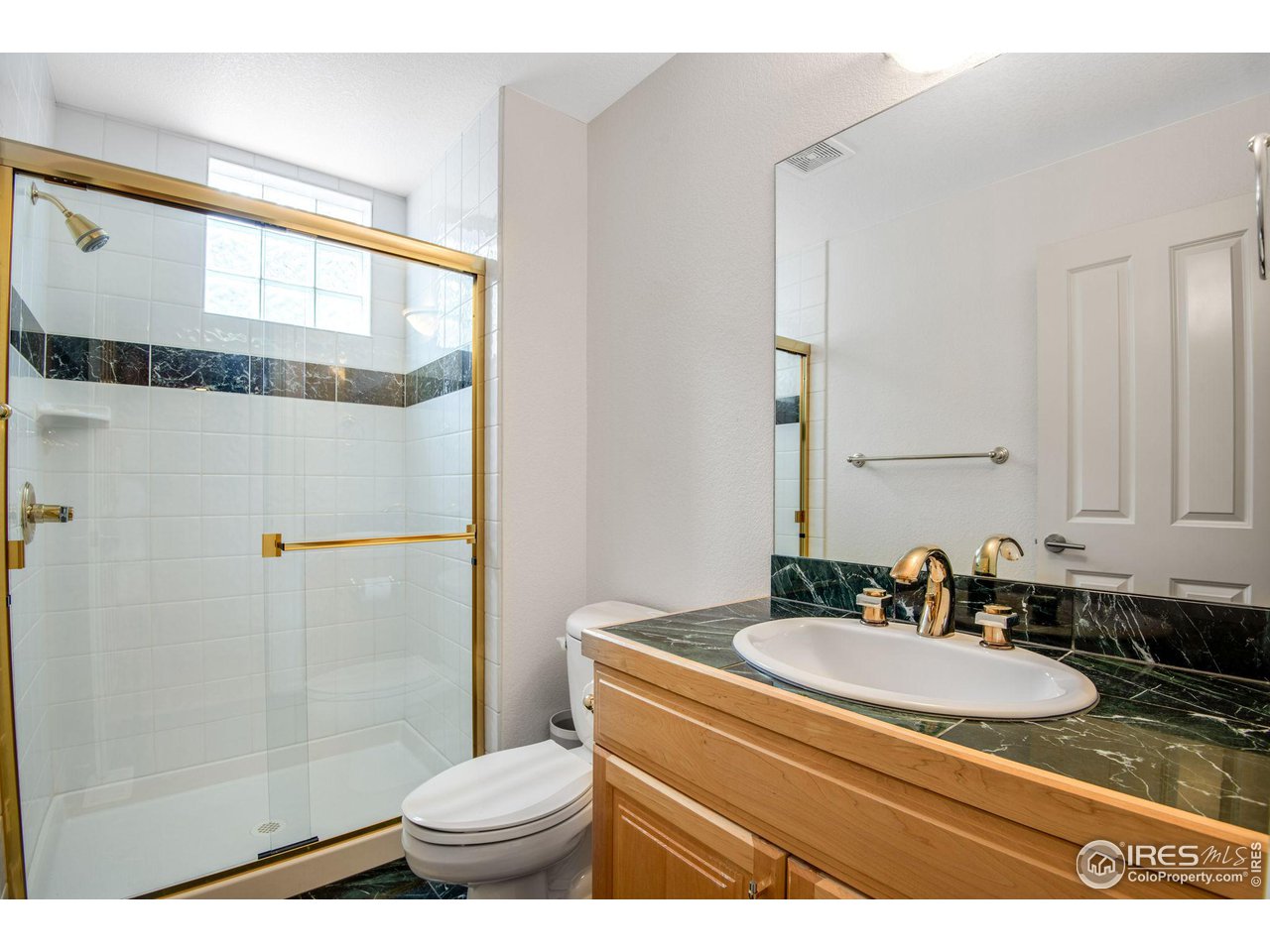 4026 Nevis Street Boulder, CO 80301 - Photo 21 of 40 a bathroom with a granite countertop sink mirror vanity and toilet