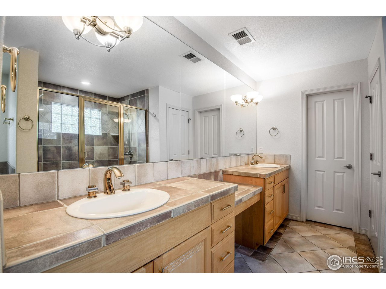 4026 Nevis Street Boulder, CO 80301 - Photo 25 of 40 a bathroom with a sink double vanity granite tub shower and a mirror