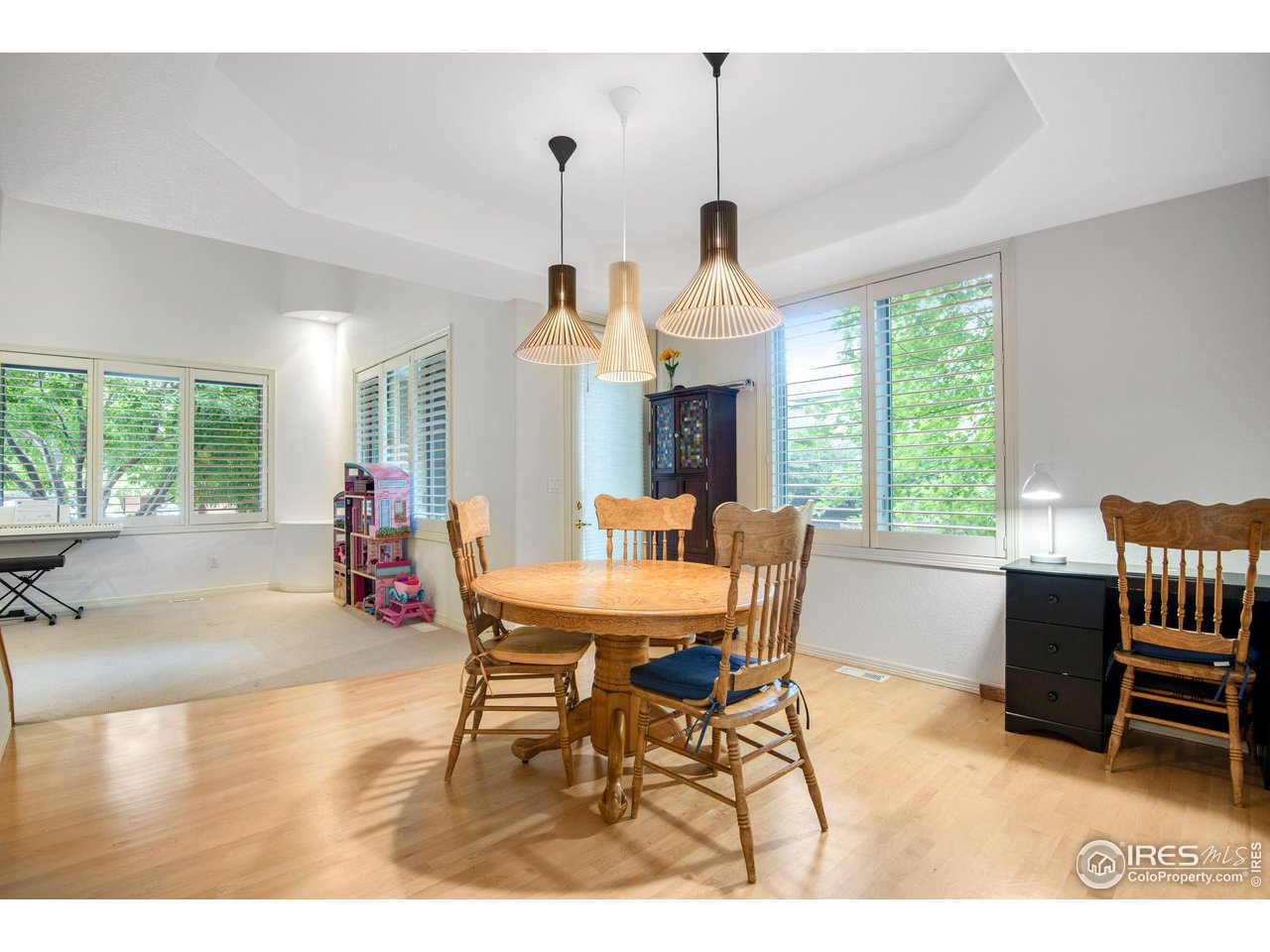 4026 Nevis Street Boulder, CO 80301 - Photo 7 of 40 a view of a dining room and livingroom with furniture wooden floor a chandelier