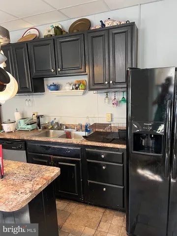 a kitchen with stainless steel appliances a stove a microwave and wooden cabinets