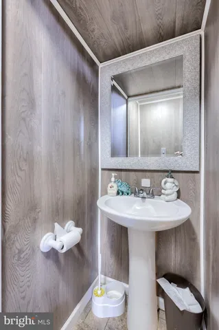 a kitchen with stainless steel appliances granite countertop a sink a stove a refrigerator cabinets and chairs