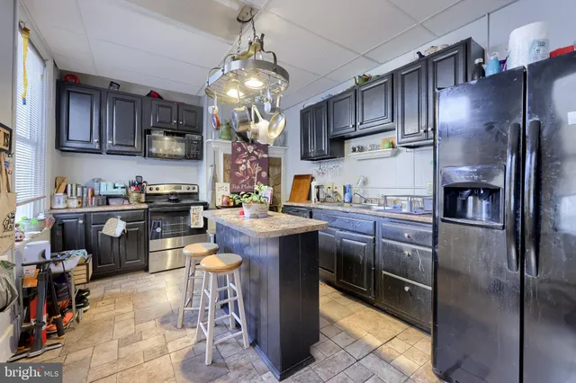 a spacious bedroom with a bed and a chandelier