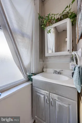 a view of a livingroom with workspace and a window