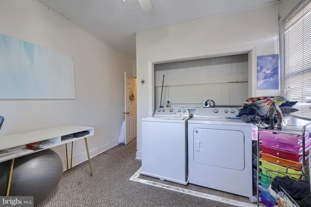 a living room with furniture and a baby crib