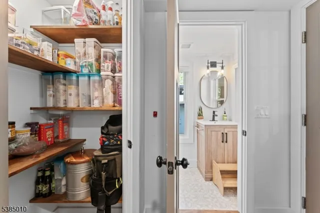a view of a bathroom with a window and a mirror