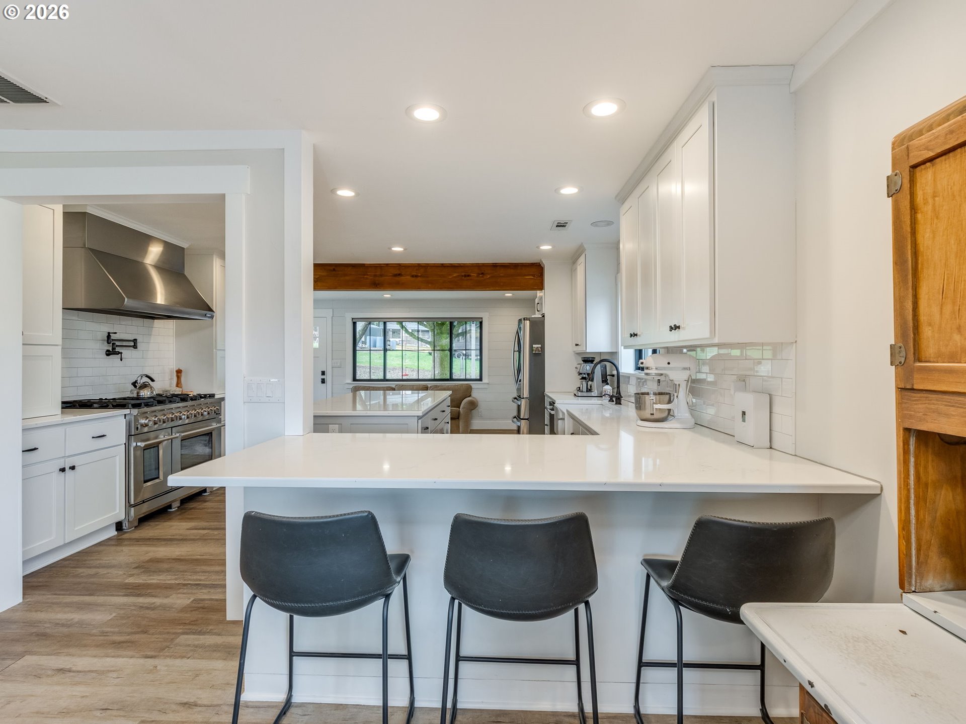 5801 Northeast Abbey Road Carlton, OR 97111 - Photo 12 of 48 a large kitchen with granite countertop a stove a sink a table and chairs
