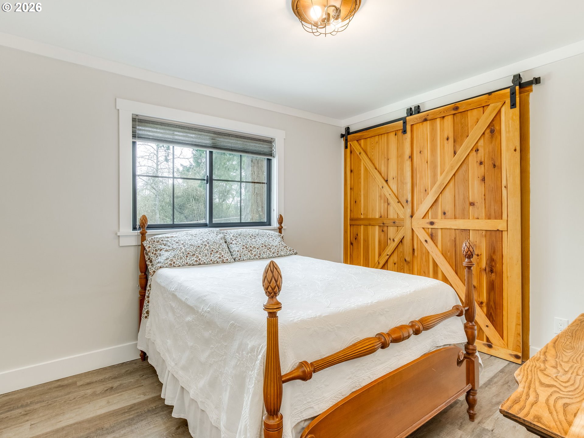 5801 Northeast Abbey Road Carlton, OR 97111 - Photo 23 of 48 a bed sitting in a bedroom next to a window