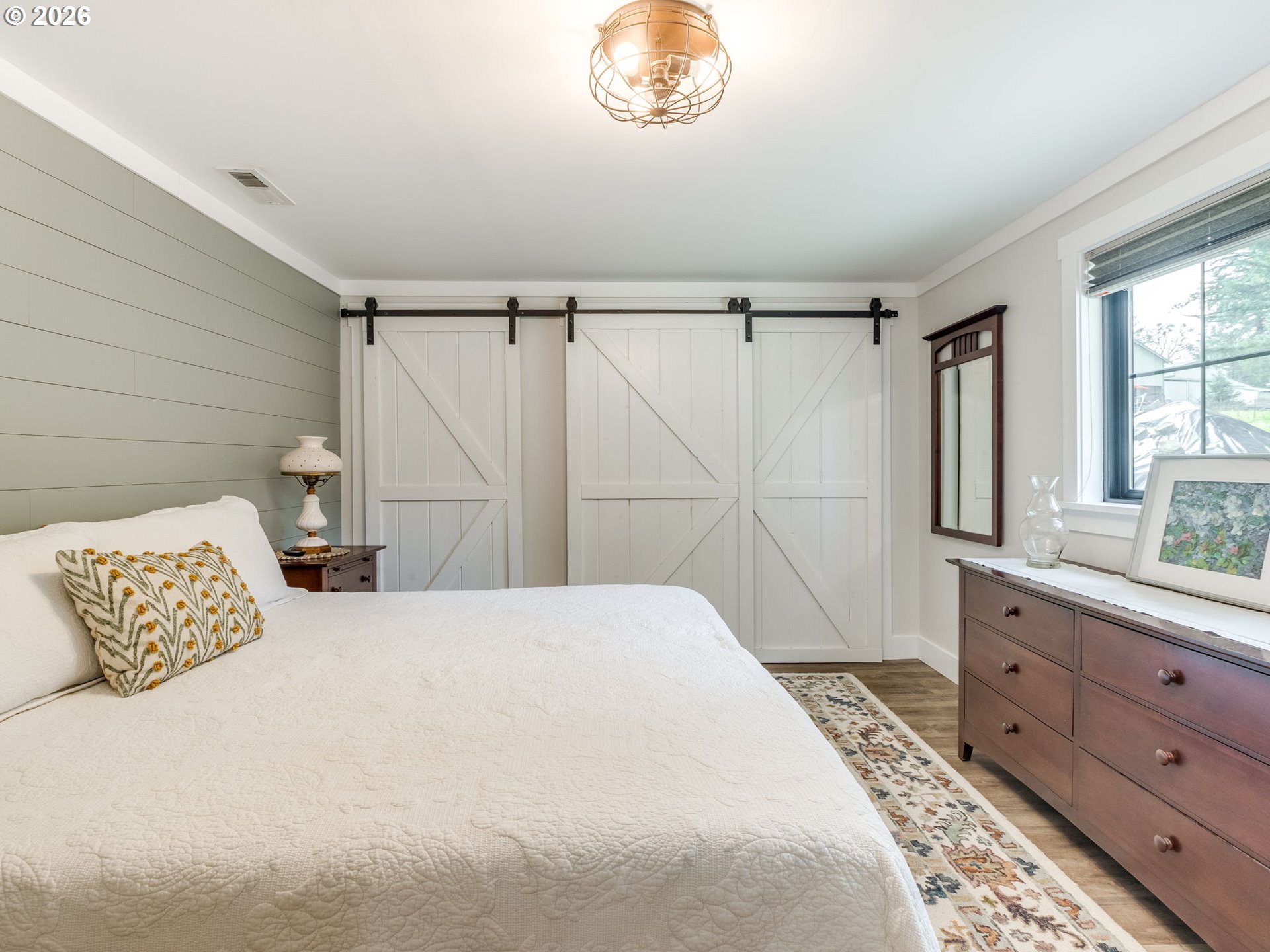 5801 Northeast Abbey Road Carlton, OR 97111 - Photo 26 of 48 a bedroom with a large bed and a chandelier