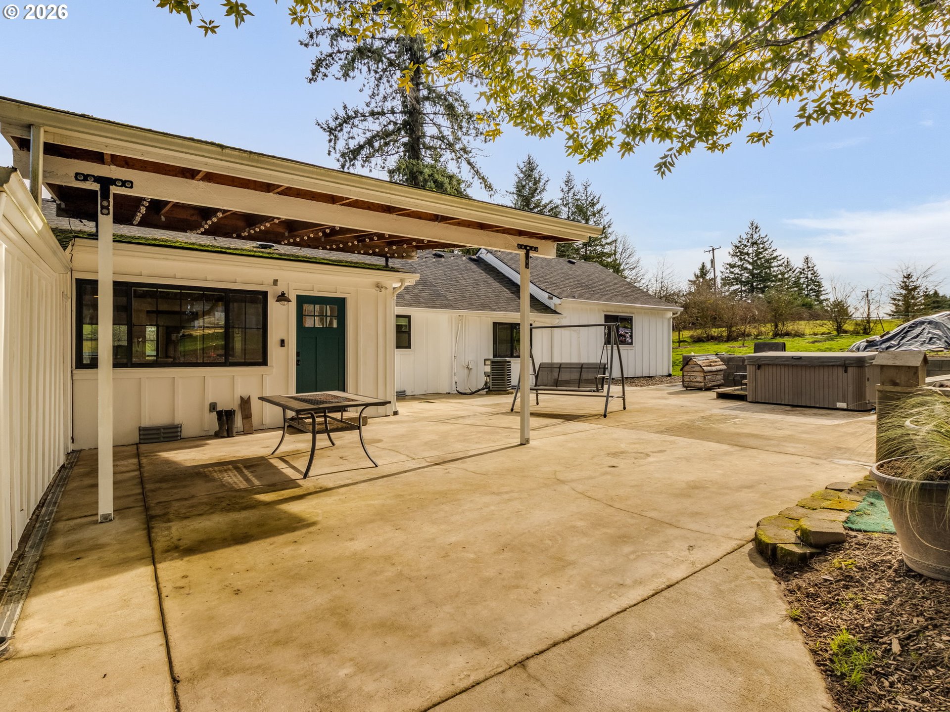 5801 Northeast Abbey Road Carlton, OR 97111 - Photo 29 of 48 a view of a patio with table and chairs potted plants and a large tree