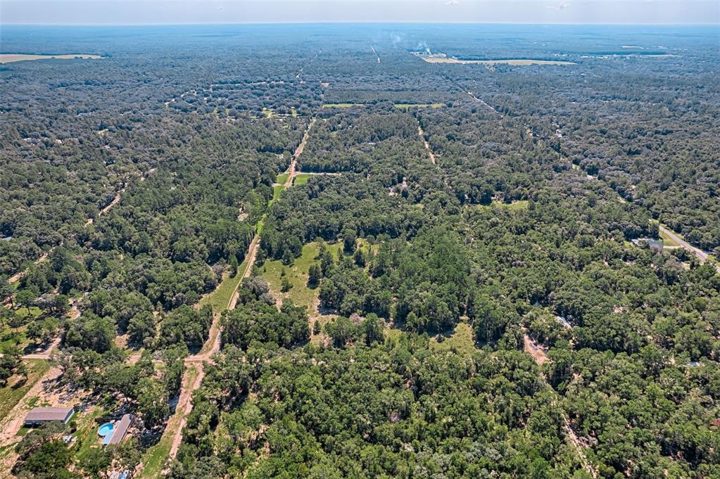 0 Northeast 83rd Lane Bronson, FL 32621 - Photo 4 of 4 an aerial view of house with yard and mountain in the back