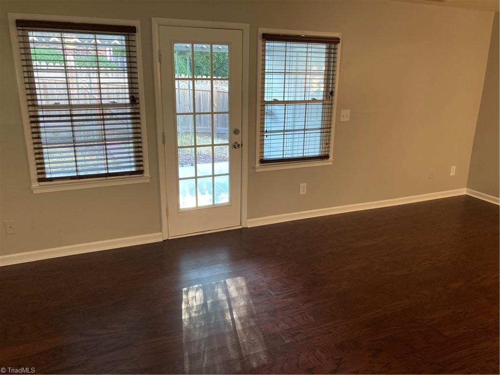 2930 St Marks Road Southwest, Unit E Winston-Salem, NC 27103 - Photo 13 of 49 Living room back wall is full of light, and leads onto covered patio.