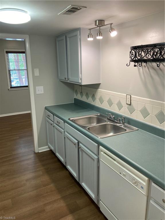 2930 St Marks Road Southwest, Unit E Winston-Salem, NC 27103 - Photo 9 of 49 View from back of kitchen, looking right, shows dishwasher, sink, lots more cabinets and a stylish pot-holder. All kitchen outlets are GFCI-enabled, meaning this home has upgraded safety standards.