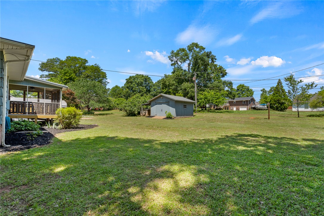 1509 869 Anderson, SC 29621 - Photo 37 of 45 A spacious yard with mature trees and a screened-in porch offers tranquil outdoor living.
