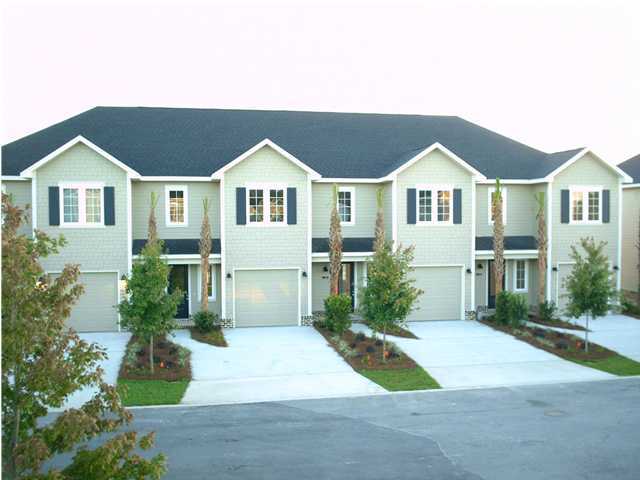73 South Church Street, Unit 2 Santa Rosa Beach, FL 32459 - Photo 1 of 18 a front view of a house with a yard and trees
