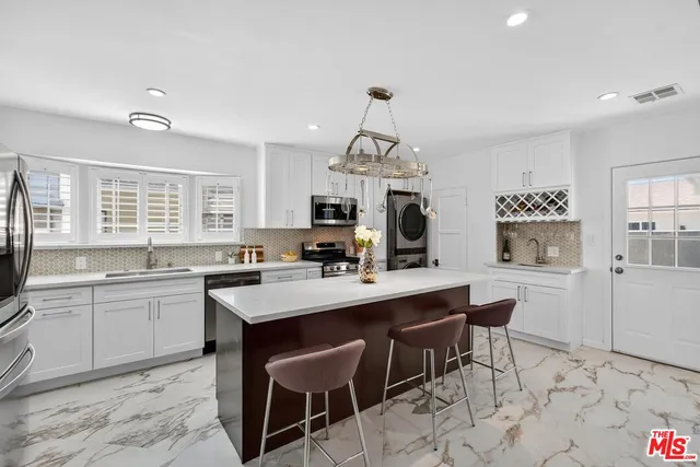 a kitchen with a dining table and chairs