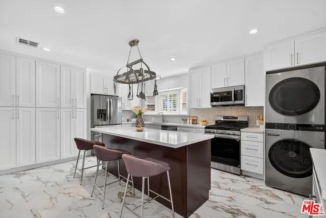 a view of kitchen with sink refrigerator and cabinets