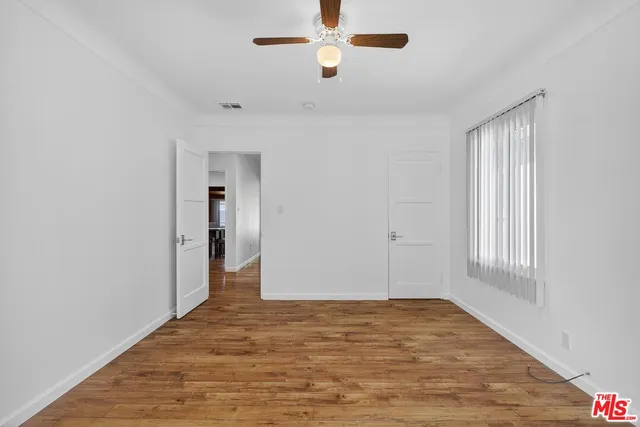 a view of white house with a small yard