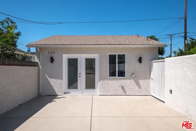 a kitchen with a sink and a stove top oven with wooden floor