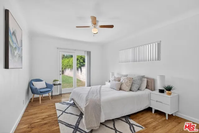 a view of a livingroom with a ceiling fan and window