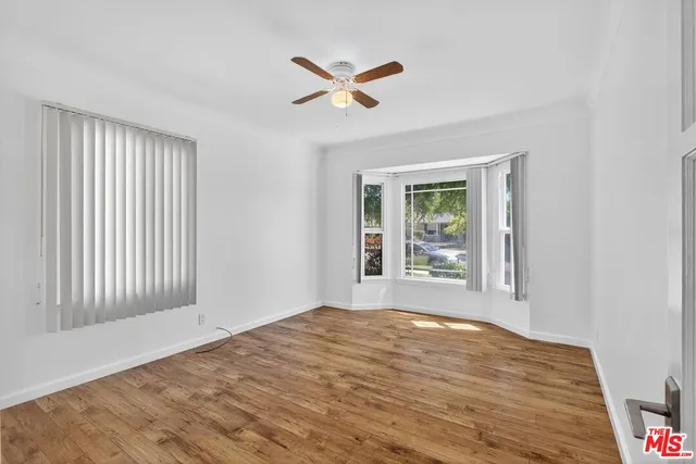 a view of a room with wooden floor