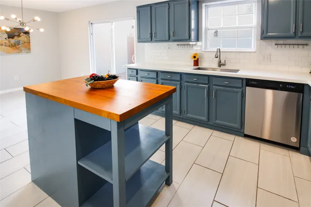 a kitchen with stainless steel appliances cabinets a sink and a counter top space