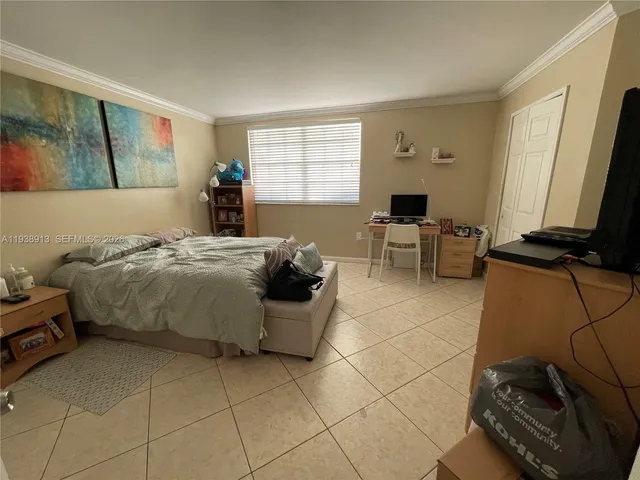 a bedroom with a bed and a television