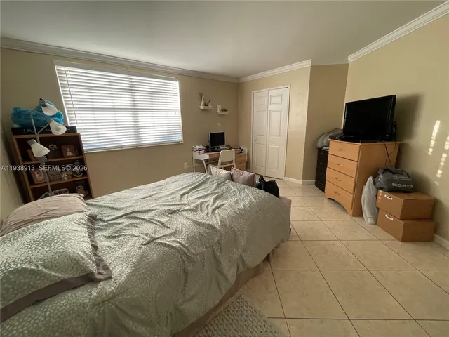 a bedroom with a bed and a tv on table
