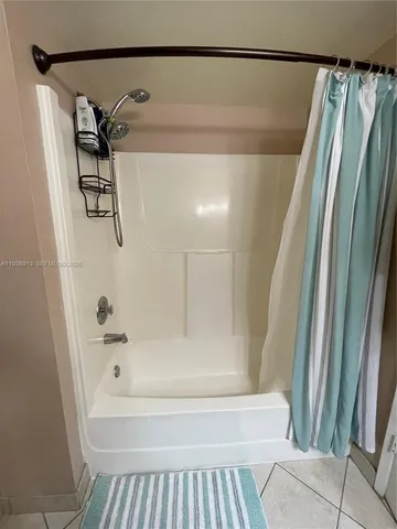 a utility room with dryer washer and a view of living room