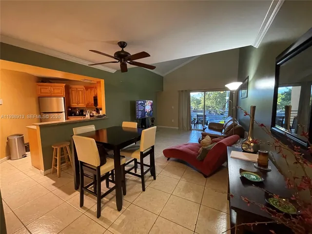 a dining room with furniture and a chandelier