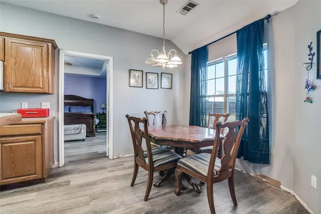 a kitchen with a sink cabinets and wooden floor