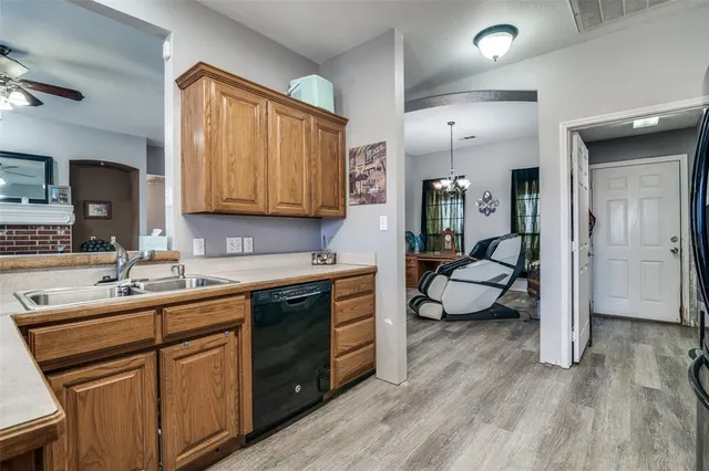 a kitchen with sink refrigerator and cabinets