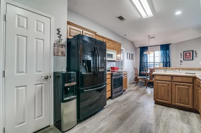 a kitchen with sink cabinets and wooden floor