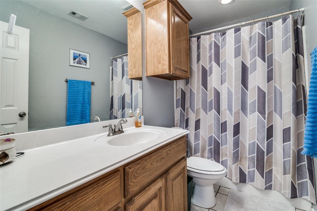 2900 County Road 643 Nevada, TX 75173 - Photo 22 of 36 a bathroom with a sink a toilet and a mirror