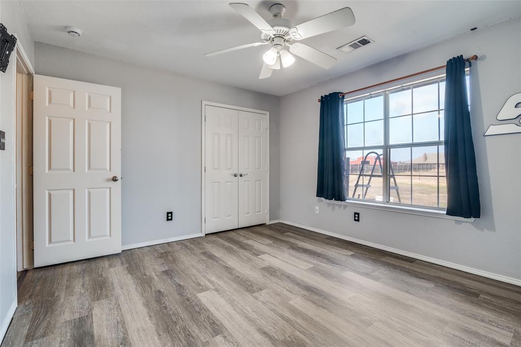 2900 County Road 643 Nevada, TX 75173 - Photo 24 of 36 a view of an empty room with a window and wooden floor