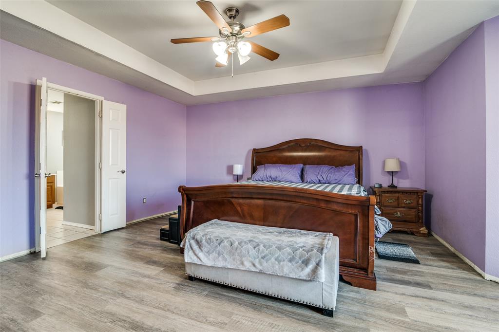 2900 County Road 643 Nevada, TX 75173 - Photo 26 of 36 a bedroom with a bed and a chandelier