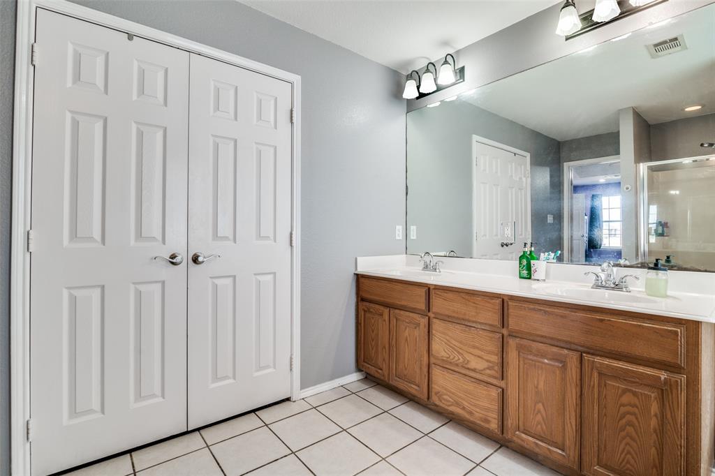 2900 County Road 643 Nevada, TX 75173 - Photo 30 of 36 a spacious bathroom with a double vanity sink a mirror and a